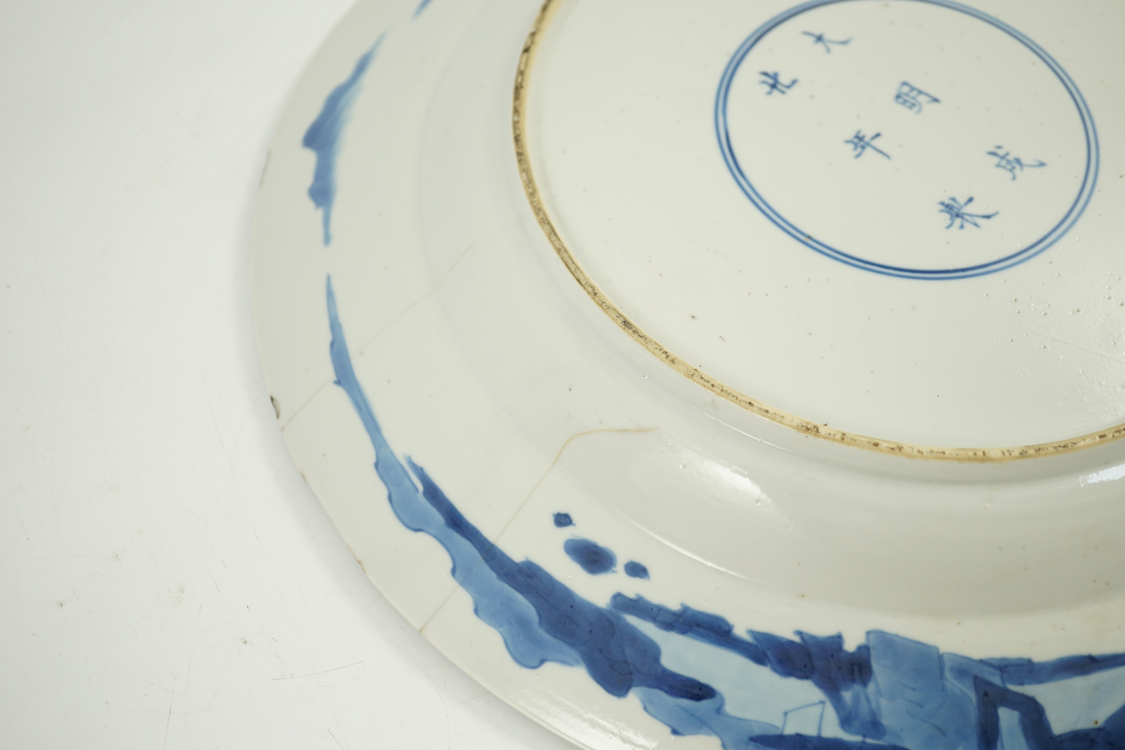 A Chinese blue and white ‘court scene’ dish, Kangxi period, two rim cracks and small splinter chips